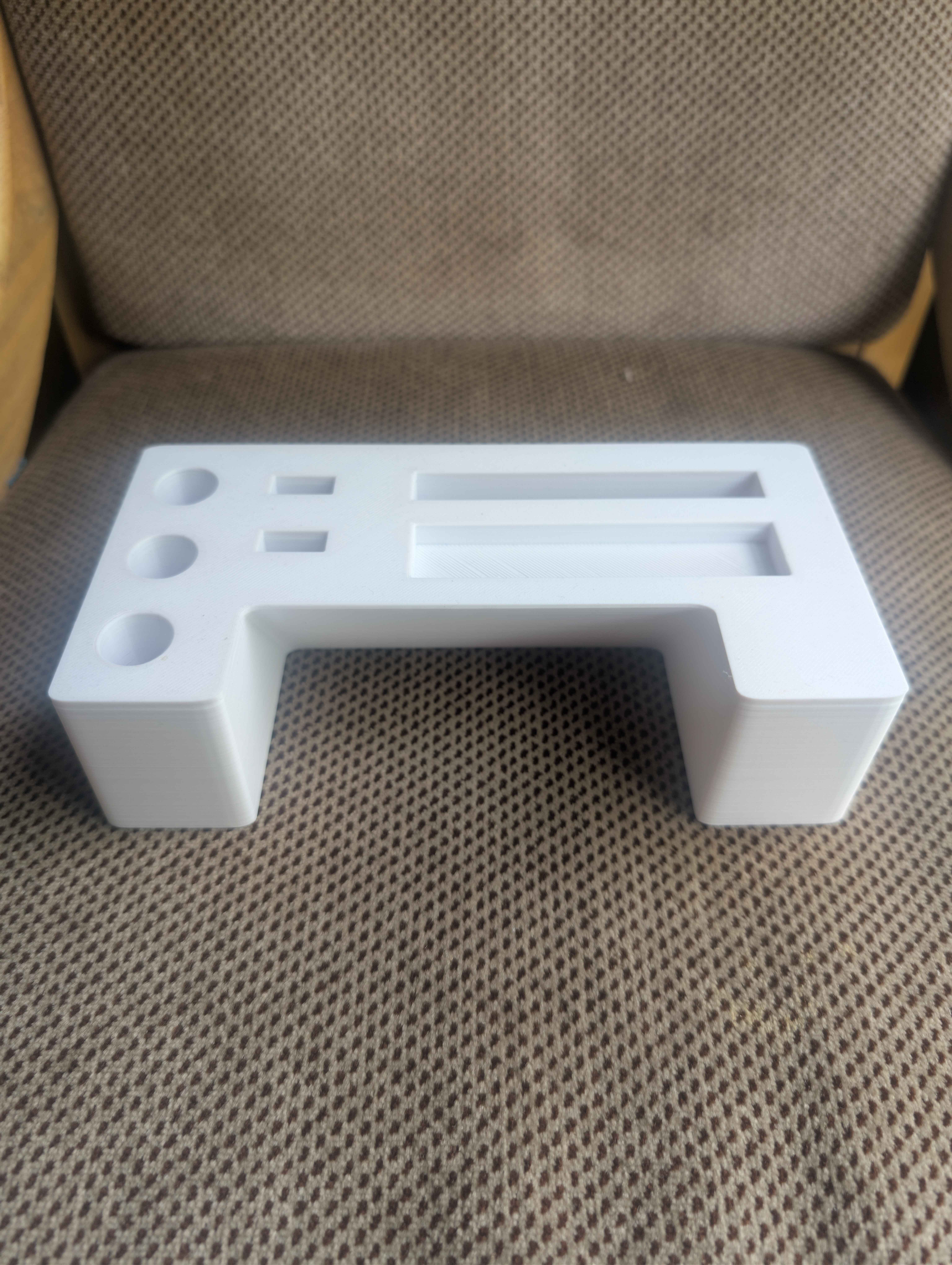 Small white PETG printed utility handle with raised detail
